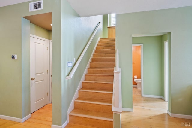 stairs with hardwood / wood-style flooring