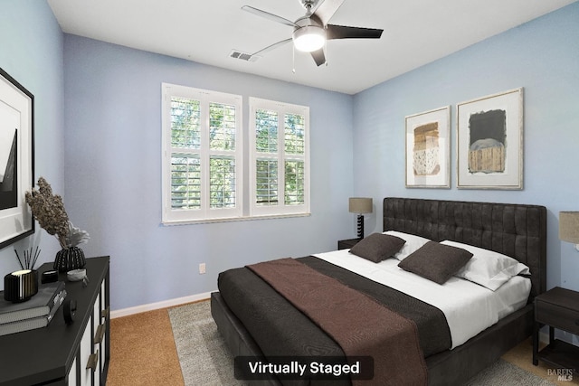 carpeted bedroom with baseboards and ceiling fan