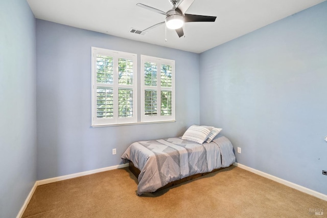 bedroom featuring carpet, baseboards, and a ceiling fan