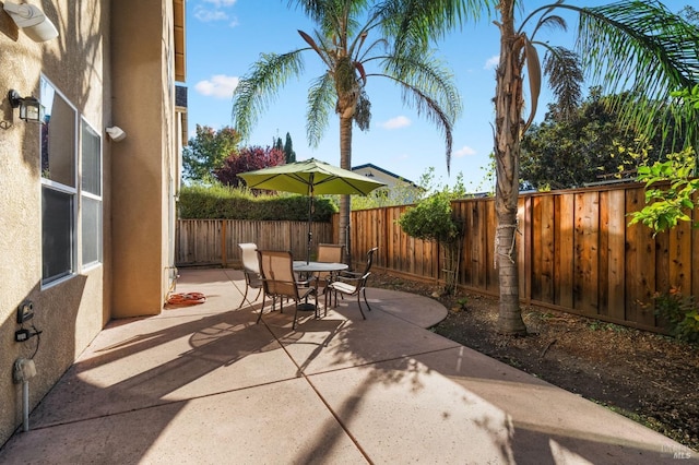 view of patio featuring outdoor dining space and a fenced backyard