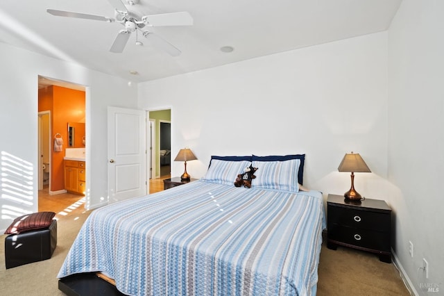 carpeted bedroom featuring ensuite bathroom and ceiling fan