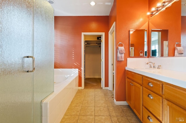 bathroom with shower with separate bathtub, tile patterned floors, and vanity