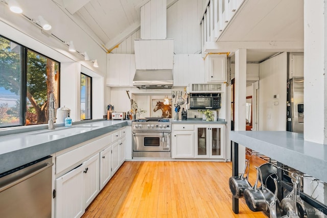 kitchen with white cabinetry, stainless steel appliances, light hardwood / wood-style floors, and sink