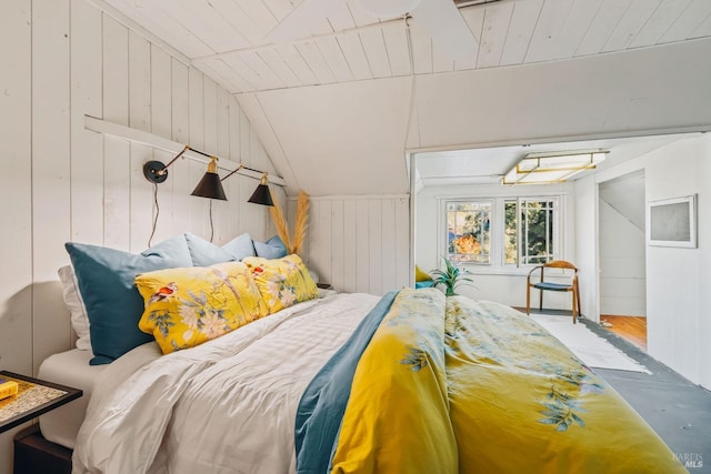 bedroom with wood walls, vaulted ceiling, a closet, and wood-type flooring