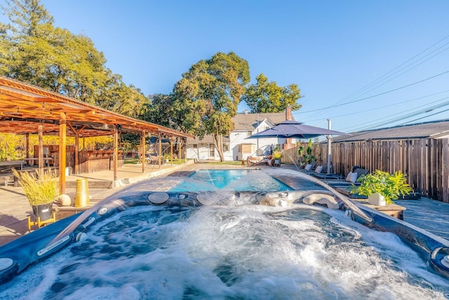 view of pool featuring a hot tub and a patio