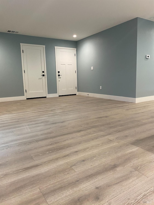 spare room featuring recessed lighting, baseboards, visible vents, and light wood-type flooring