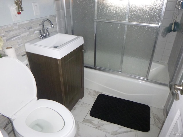 full bathroom featuring combined bath / shower with glass door, tile walls, tasteful backsplash, vanity, and toilet