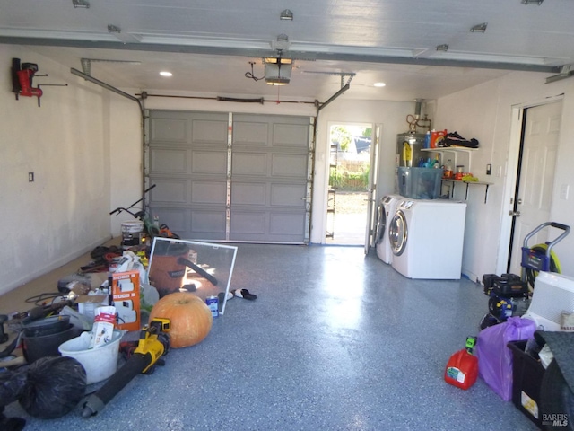 garage with a garage door opener and washing machine and dryer