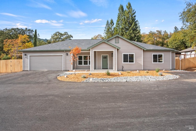 single story home featuring a garage and covered porch