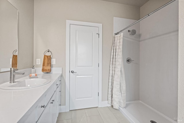 bathroom featuring a shower with curtain, vanity, and tile patterned flooring