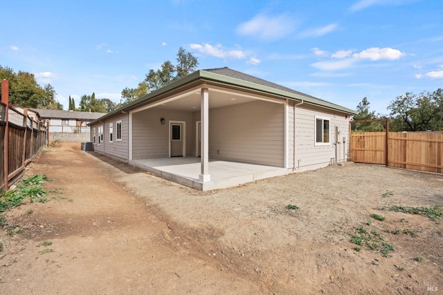 back of property with a patio area and cooling unit