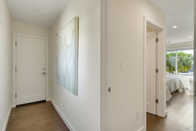 hallway with hardwood / wood-style floors