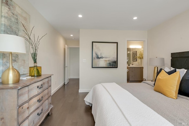 bedroom with ensuite bath and dark hardwood / wood-style floors