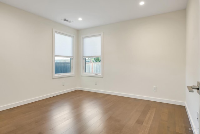 unfurnished room with hardwood / wood-style floors