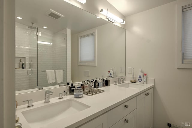 bathroom featuring vanity and a shower with shower door