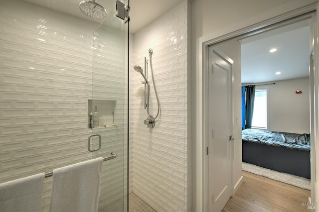 bathroom featuring wood-type flooring and a shower with door