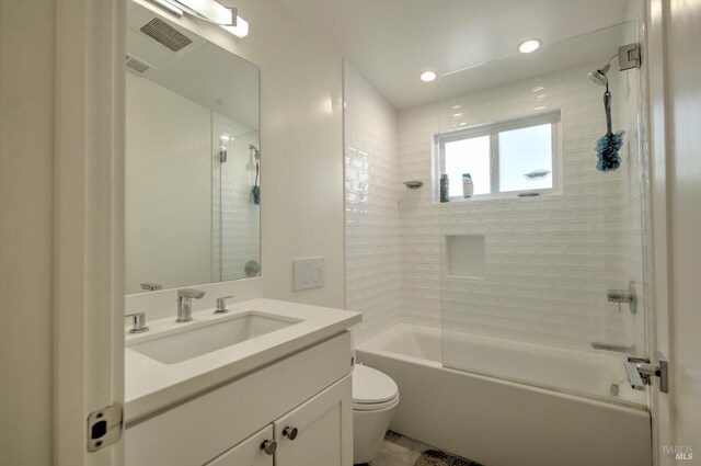 full bathroom featuring toilet, tiled shower / bath combo, and vanity