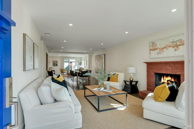 living room with a fireplace and hardwood / wood-style flooring