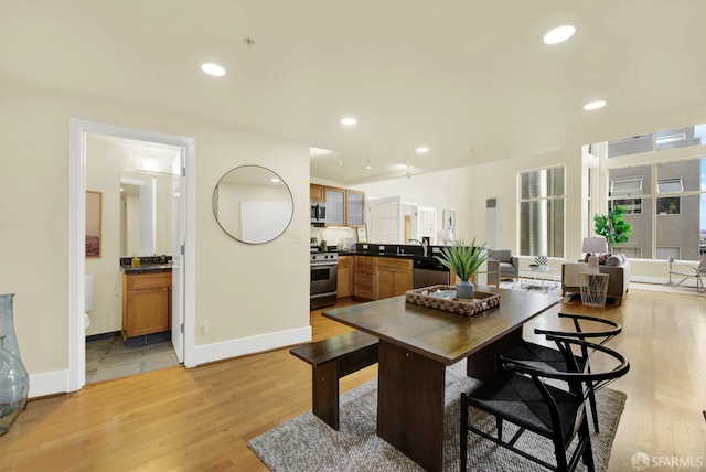 dining room with light hardwood / wood-style flooring and sink