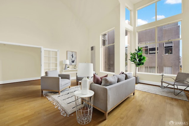 living room featuring hardwood / wood-style flooring and a high ceiling