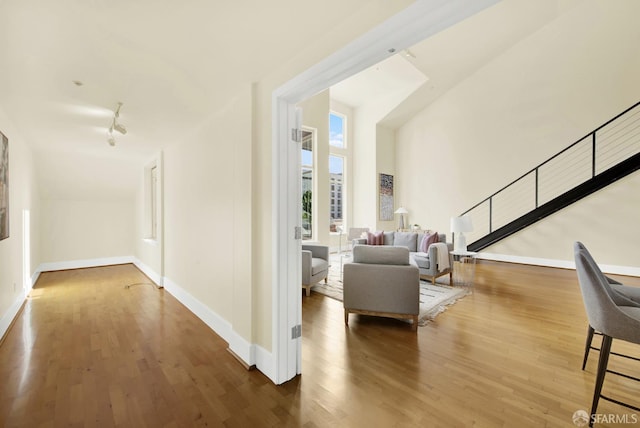 corridor with hardwood / wood-style flooring