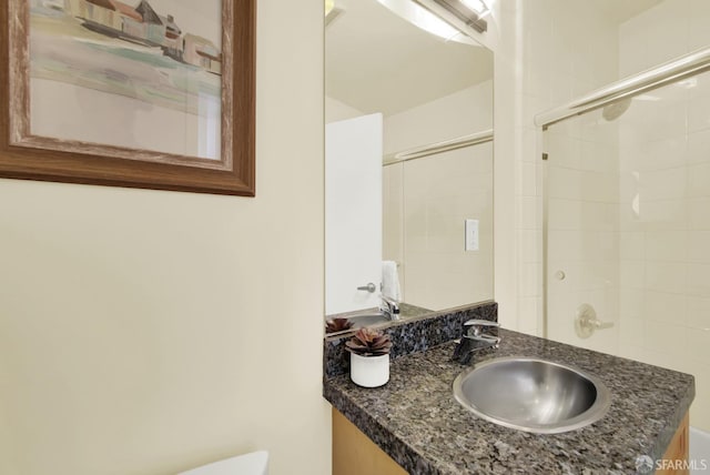 bathroom with vanity and a shower with shower door