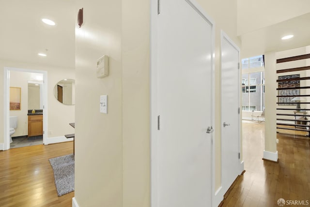 hallway with light hardwood / wood-style flooring