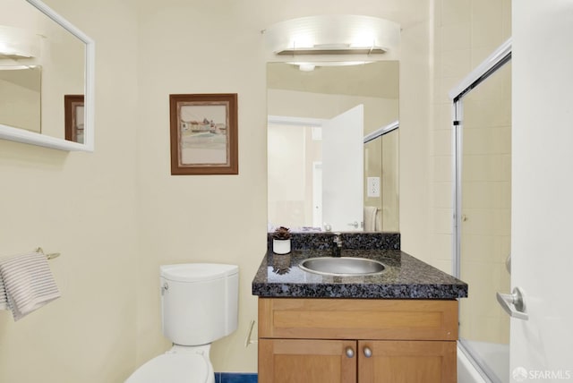 full bathroom with vanity, toilet, and shower / bath combination with glass door