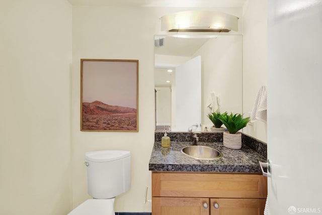 bathroom with vanity and toilet