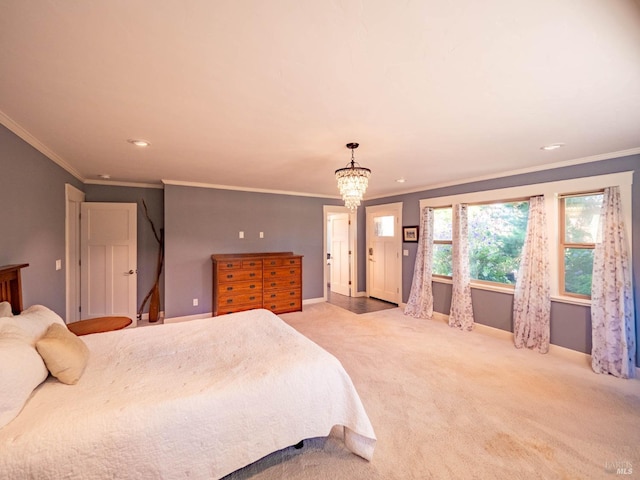 carpeted bedroom featuring ornamental molding and a notable chandelier