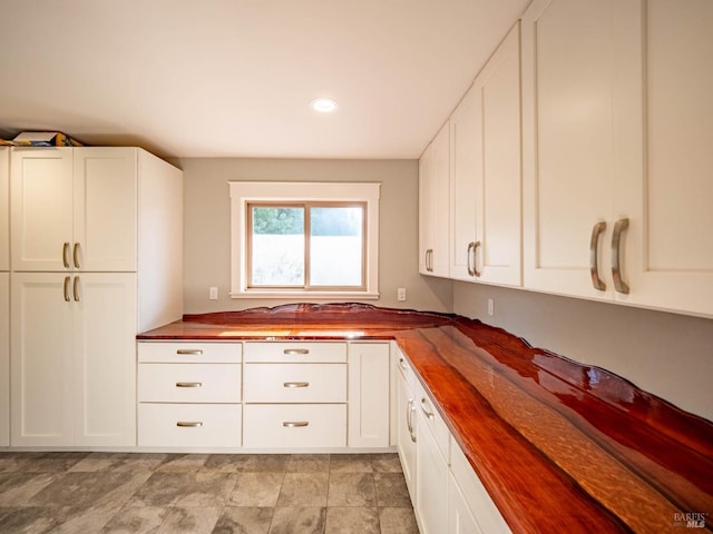 kitchen with white cabinets and butcher block counters