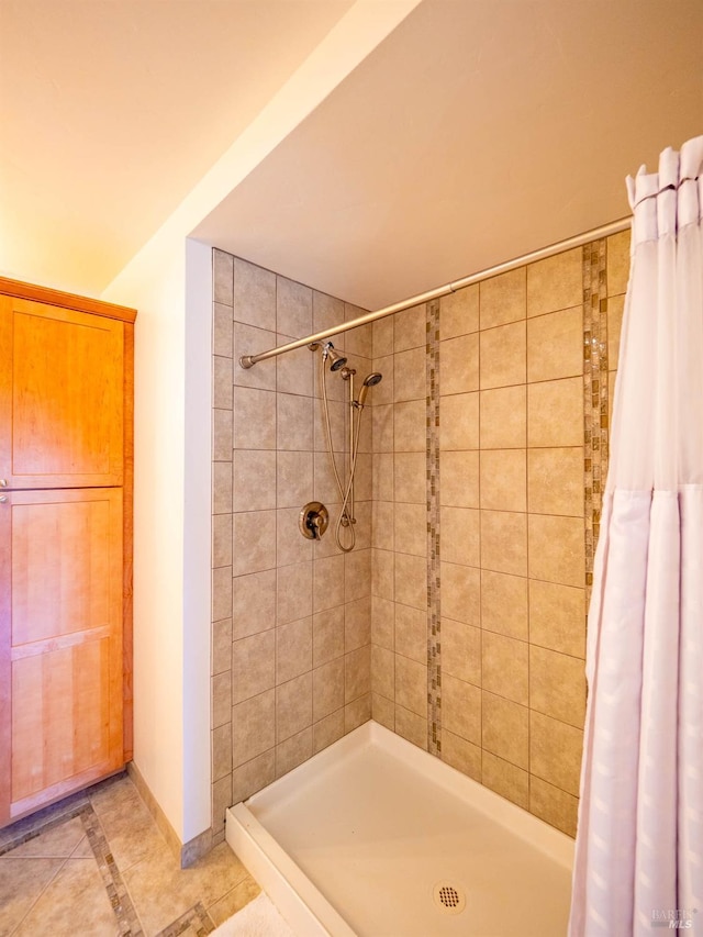 bathroom featuring walk in shower and tile patterned flooring