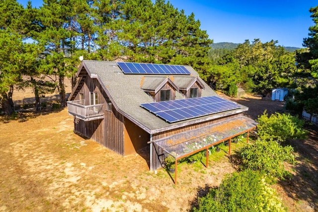 43500 Crispin Rd, Manchester, CA 95459 - back of house featuring solar panels, a shed, a shingled roof, an outdoor structure, and a wooden deck