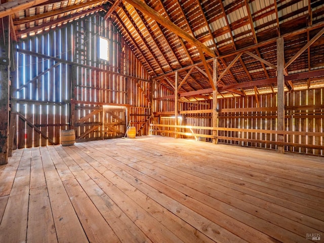 misc room featuring high vaulted ceiling and wood-type flooring