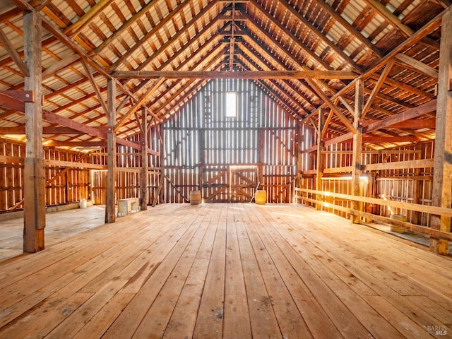 misc room with lofted ceiling and wood-type flooring