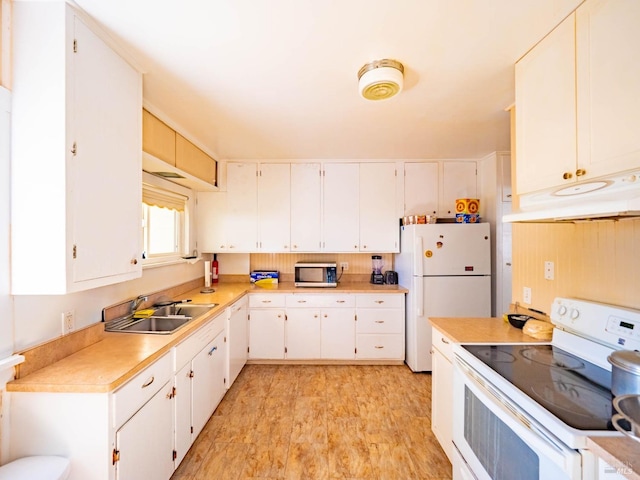 kitchen featuring white cabinetry, white appliances, sink, and light hardwood / wood-style flooring