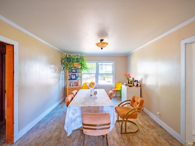 dining room with ornamental molding and light wood-type flooring