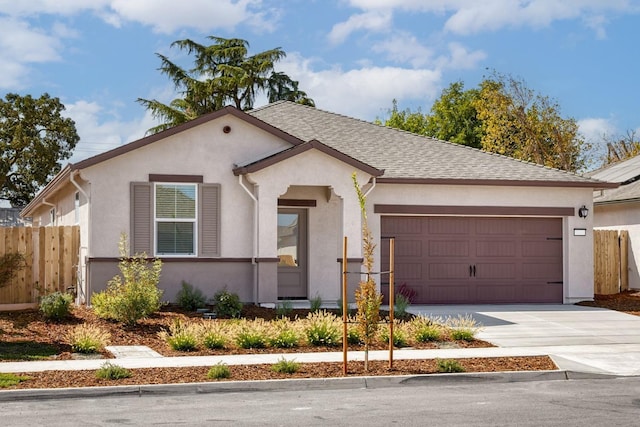 view of front facade with driveway, a garage, roof with shingles, fence, and stucco siding