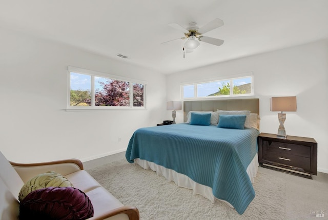 bedroom with ceiling fan and light carpet