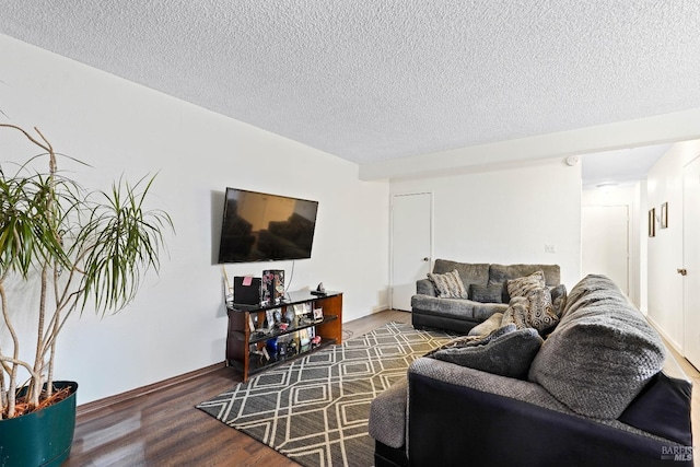 living room with a textured ceiling and wood finished floors