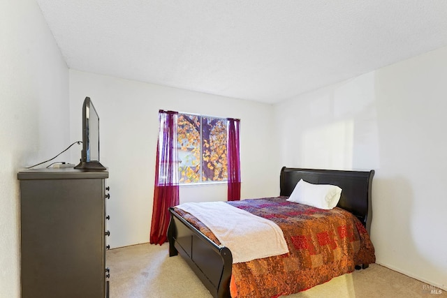 bedroom featuring light colored carpet