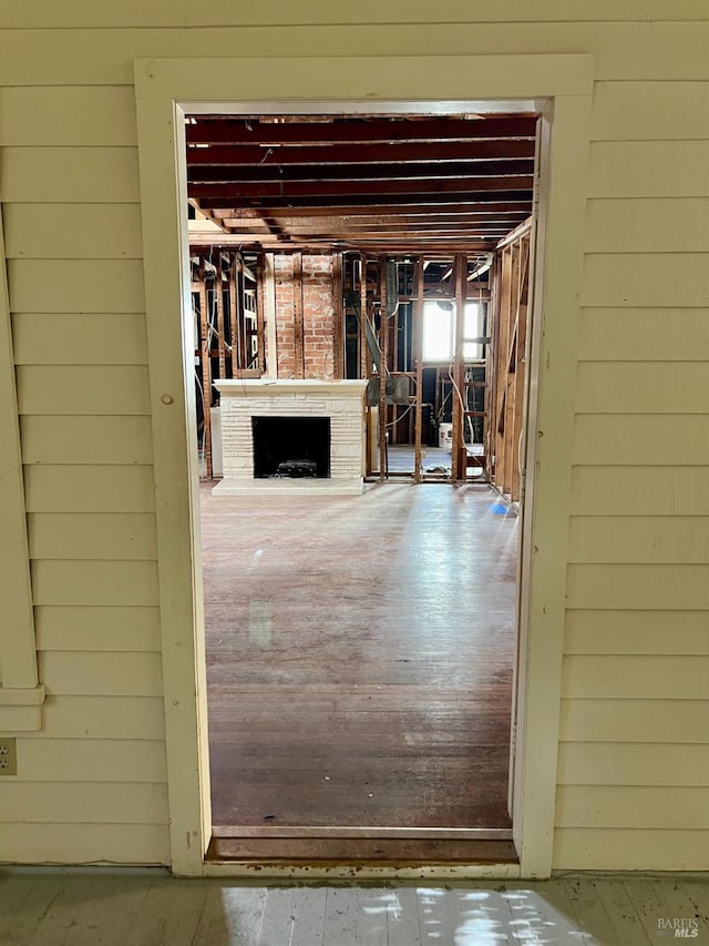 basement featuring a fireplace and wood walls