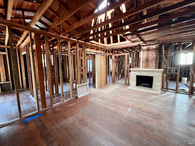 miscellaneous room with hardwood / wood-style floors and vaulted ceiling