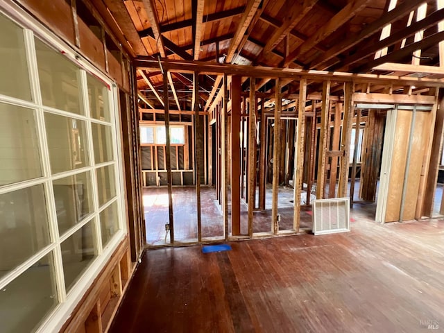 misc room featuring wood-type flooring and lofted ceiling