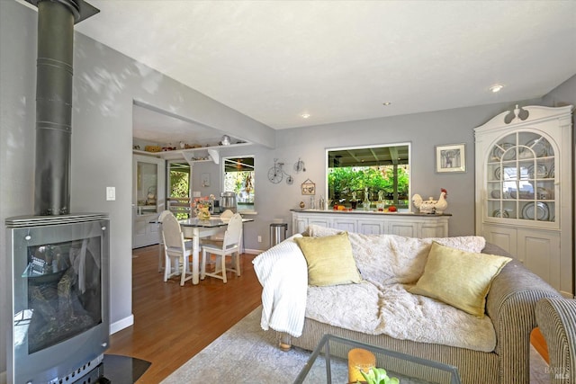 living room with hardwood / wood-style floors and a wood stove