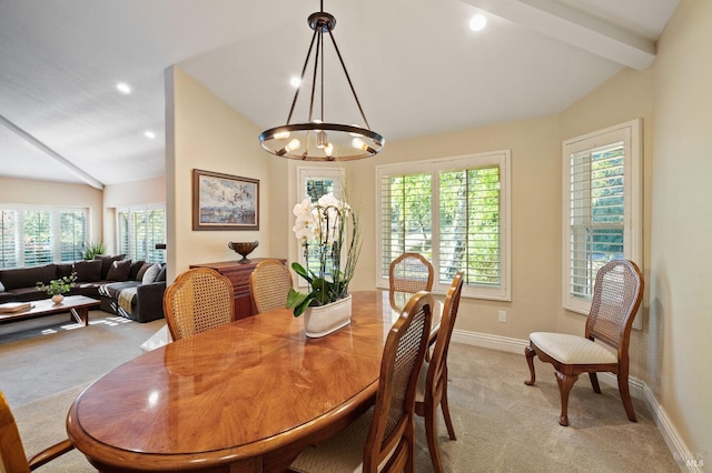 dining area featuring a chandelier, light carpet, plenty of natural light, and lofted ceiling with beams