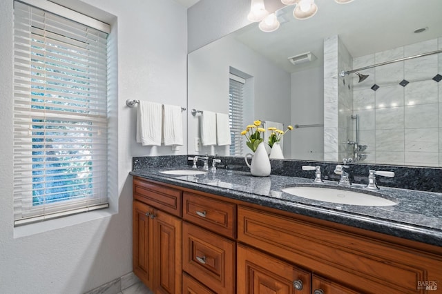 bathroom featuring vanity and a tile shower