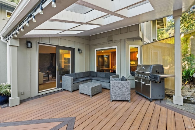 wooden terrace featuring outdoor lounge area and grilling area