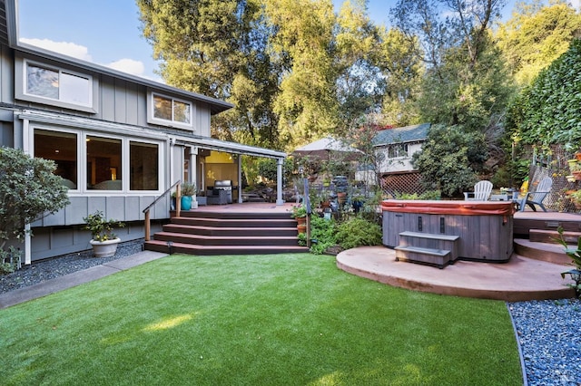 view of yard with a wooden deck and a hot tub