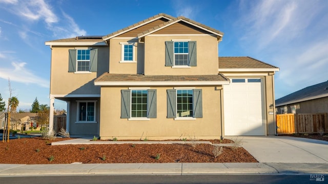 view of front property with a garage and solar panels